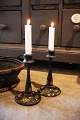 A pair of old Swedish wooden candlesticks painted with floral motifs...