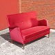 Ældre to 
personers sofa 
betrukket med 
slidstærkt rødt 
velour stof og 
ben i mørk 
lakeret ...