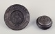 Hjorth, 
Bornholm.
Wall relief 
and lidded jar 
in black 
terracotta.
Wall relief 
title: “Første 
...