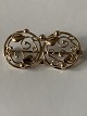 Smuk broche i 
14 karat guld, 
med flot 
detaljeret 
mønster i 
symmetrisk 
motiv.
Højde: 17,09 
...