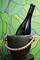 Arne Bang 
ceramic wine 
cooler with 
fine green 
glaze and 
braided bamboo 
handle. H: 
13cm. Dia.: ...