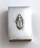 Georg Jensen. 
Sølv (925). 
Dronning. Lille 
tændstiksholder.
 Længde 4,3 cm. 
Bredde 3 cm