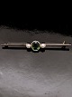 14 karat guld 
stav broche med 
turmalin