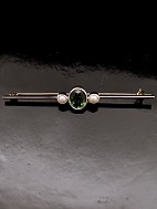14 carat gold rod brooch . with tourmaline