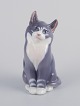 Royal 
Copenhagen. 
Porcelænsfigur 
af siddende 
kat.
Underglasur.
Modelnummer: 
115
Datering: ...