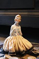 Decorative, old half doll in porcelain from the 1930s with a fine fabric 
dress...