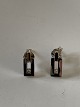 Øreringe med en 
diamant i 14 
karat hvidguld 
/ rødguld,
Stemplet BEE. 
585.
Længde 1,0 ...