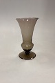 Holmegaard 
Vase, 
trompetform på 
fod. 
Røgtopas-farvet 
glas. Designet 
af Jacob E. 
Bang ca. ...