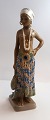 Dahl Jensen. 
Porcelænsfigur. 
Pige fra Øst 
Sierra Leone. 
Model # 1117. 
Højde 25 cm. ( 
1 sortering )