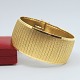 Very wide 
bracelet made 
of 18k gold.
With mat 
surface.
Clasp and two 
safety catches.
L. 19.5 ...