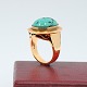 Ring of 14k 
gold, set with 
a large 
turquoise. From 
around 1970.
Front of the 
ring L. 2,5 cm. 
...