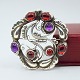 Georg Jensen jewellery.Georg Jensen; Silver brooch no. 159, adorned with granates and ...
