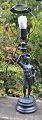 Table lamp in the shape of a standing Roman soldier, 19th century. Germany. Cast metal. Green ...