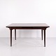 Vintage Danish Modern dining table Model 54 designed by Gunni Omann and crafted in rosewood. The ...