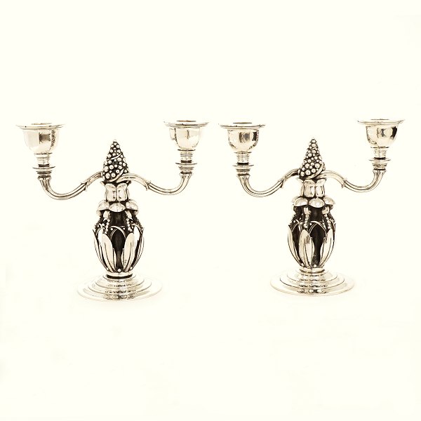 A pair of two light Georg Jensen candelabra, sterlingsilver. #244. Made in the 
period 1925-1932. Dated 1931. H: 21,2cm. B: 23,5cm. W: 2.849gr