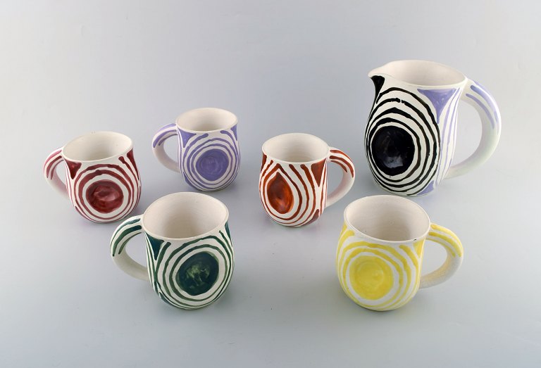 Atelier Cerenne, Vallauris. Set of five unique handpainted cups and jug in 
glazed stoneware. 1950