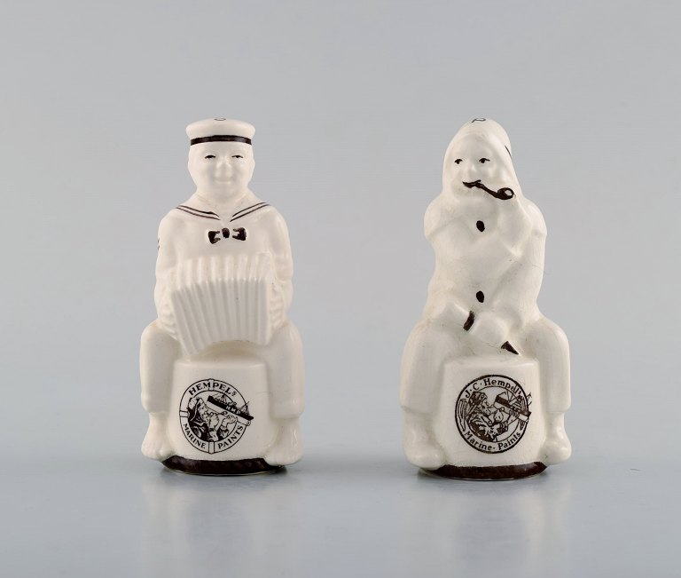 Aluminia salt / pepper set in porcelain with advertising logo for Hempel. Mid 
20th century. Sailor and fisherman.