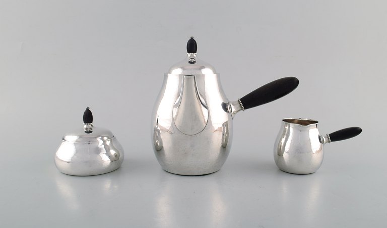 Georg Jensen art nouveau kaffekande med sukkerskål og flødekande i sterlingsølv 
med hank og knop i ibenholt. Modelnummer 80A. Designet i 1915.
