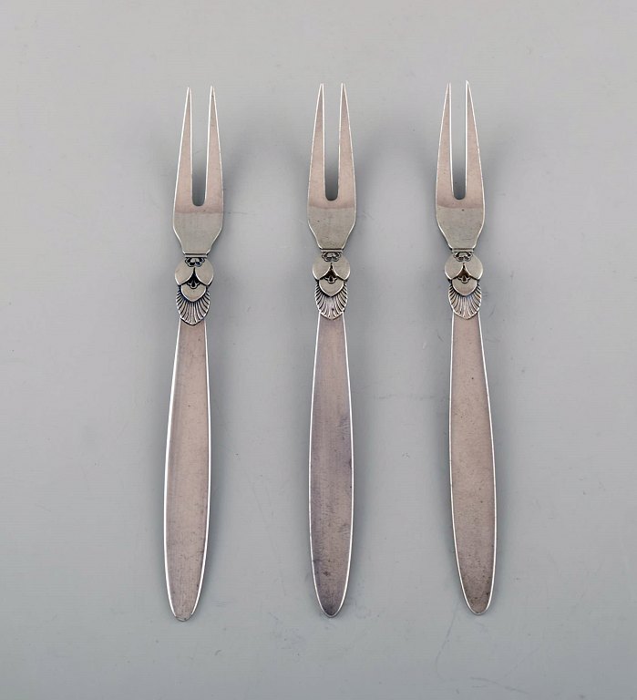 Three Georg Jensen "Cactus" sterling silver cold meat forks.
