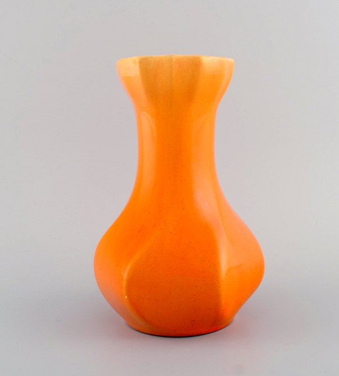 Early Rörstrand vase in glazed faience. Beautiful glaze in bright orange shades. 
Approx. 1920
