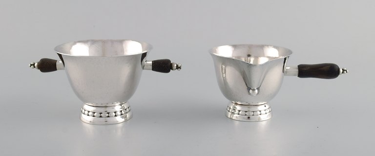 Early Georg Jensen sugar / cream set in sterling silver with handles in ebony. 
Dated 1915-1930.
