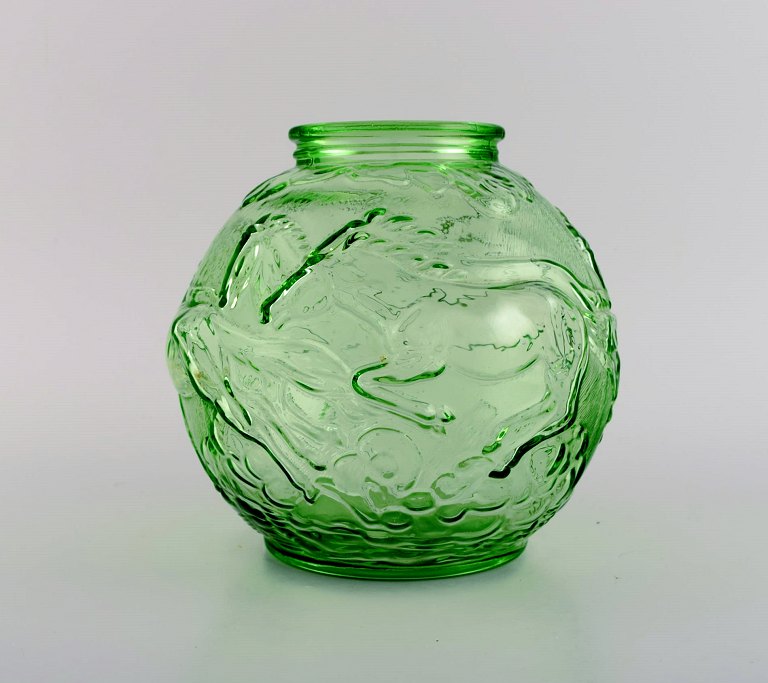 Edvin Ollers (1888-1959) for Elme. Round art deco vase in green pressed art 
glass with galloping horses. Swedish design, 1930s.
