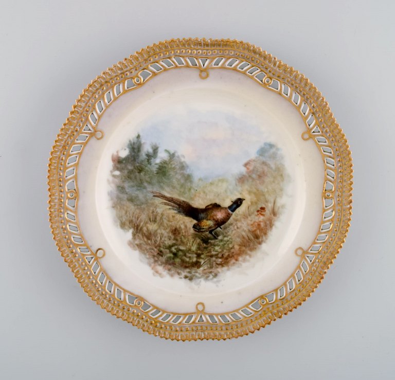 Early and rare Royal Copenhagen Fauna Danica plate in hand-painted porcelain 
with hunting motif and gold decoration. 19th century.
