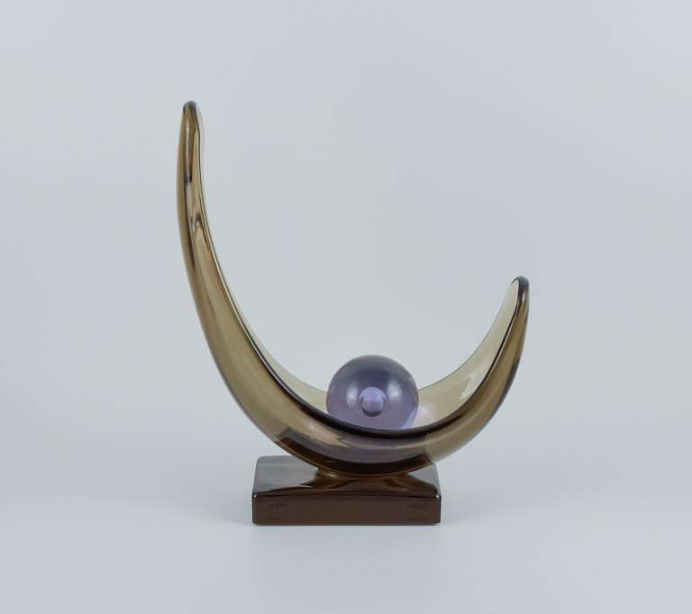 Livio Seguso, Murano, colossal and impressive art glass sculpture in smoked 
glass on a black base and accompanying glass ball in light purple.