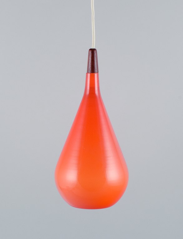 Fyens Glasværk / Kastrup-Holmegaard. "Louis Poulsen" pendant light in orange 
glass and wood.
1960s.
In perfect condition.
Dimensions: H 32.0 (including wooden mount) x D 14.0 cm.