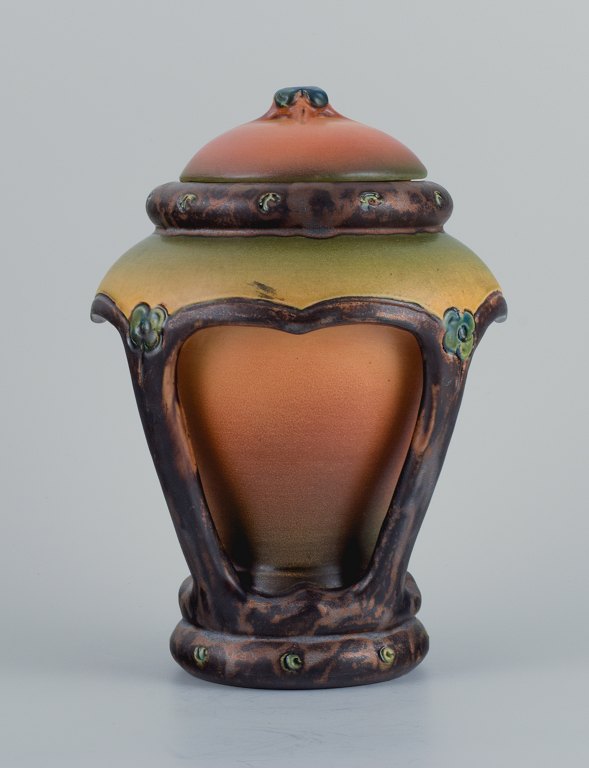 Ipsens, Denmark, beautiful Art Nouveau lid vase with glaze in orange and green 
tones.