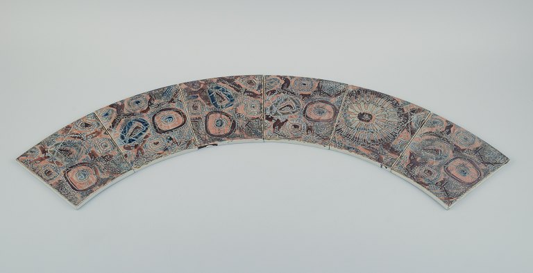 Royal Copenhagen, six Baca faience tiles with patterned glaze in brown, blue and 
green.