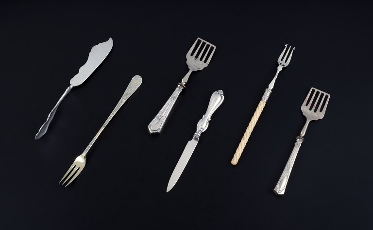 A collection of older silver cutlery consisting of fruit knife, fish knife, two 
sardine forks and two long forks.