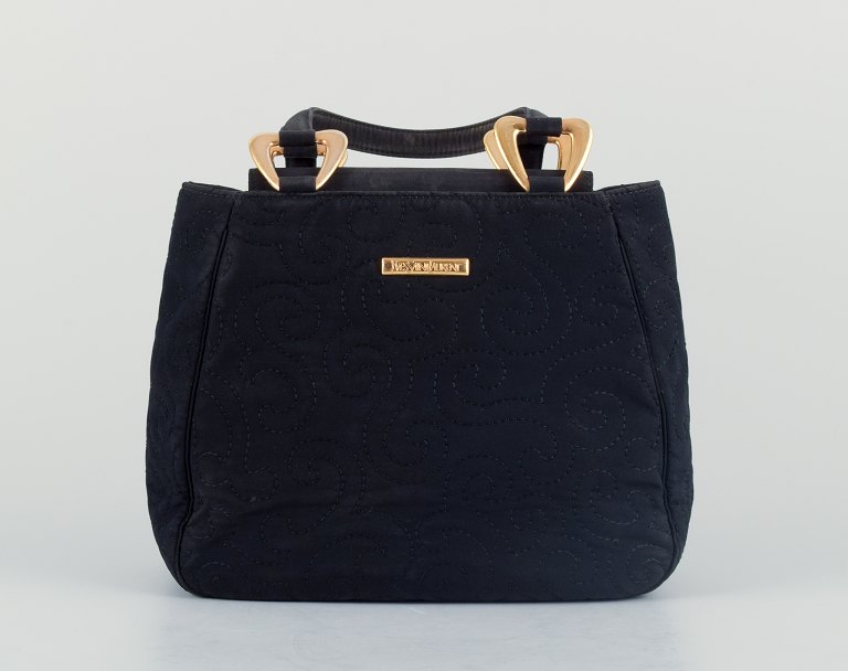 Yves Saint Laurent, small evening bag in black hand-embroidered fabric.
Interior with a small compartment.