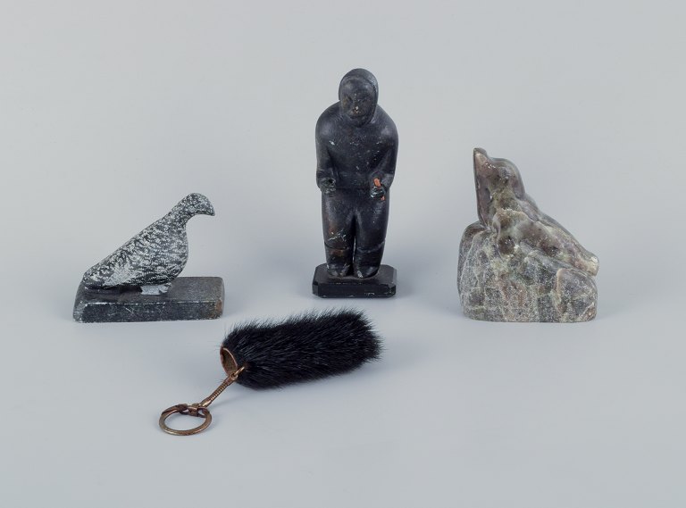 Greenlandica, three pieces of soapstone and a black pouch with a keyring. 
Features a ptarmigan, seal, and hunter.