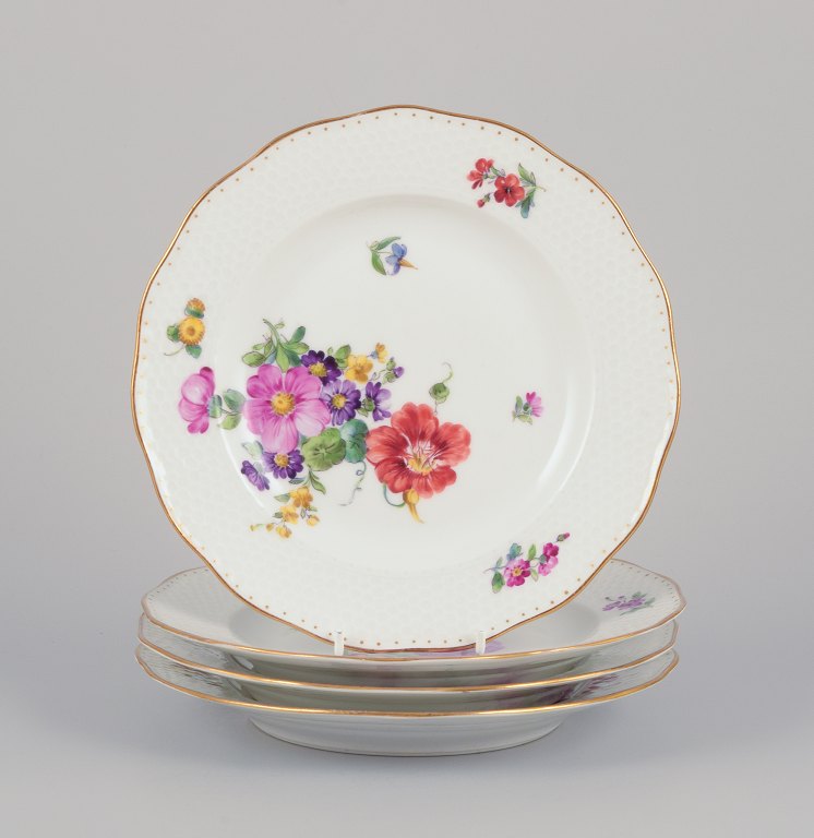 Royal Copenhagen, a set of four Saxon Flower porcelain plates.
Hand-painted with various polychrome flower motifs and gold rim.