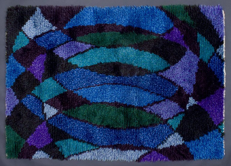 Swedish designer, handwoven rya carpet.
Geometric pattern in blue, violet, and green colors.