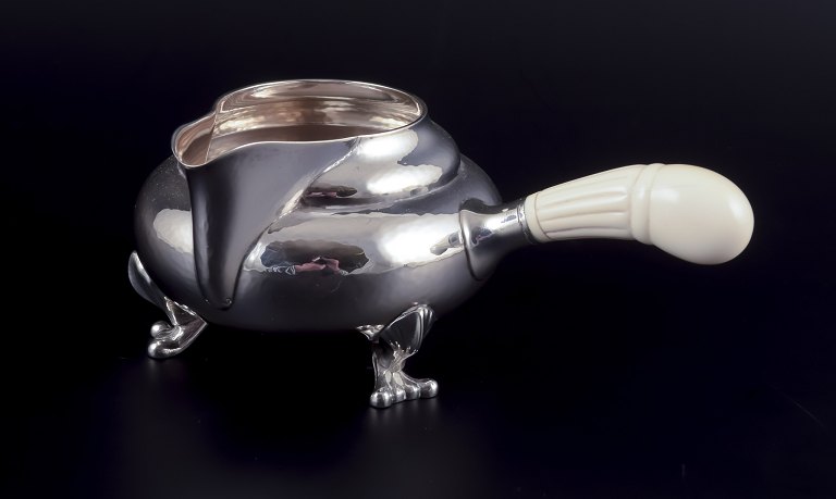 Georg Jensen Blossom creamer in hand hammered sterling silver with bone handle.