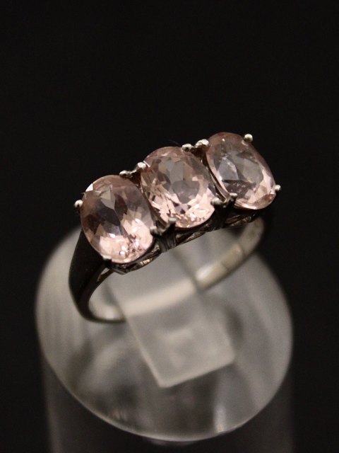 9 carat white gold ring with 3 light pink stones
